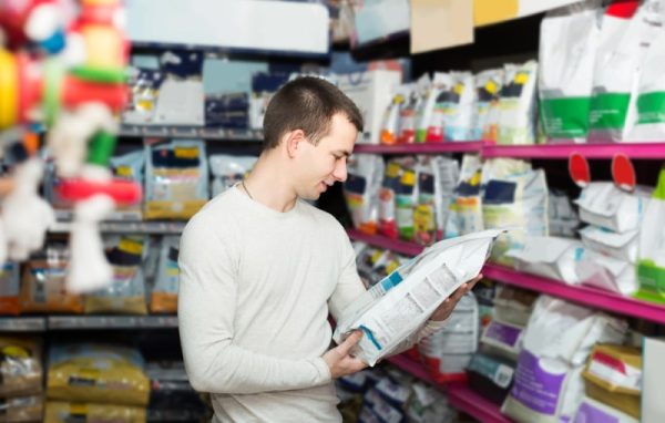 man checking dog food label