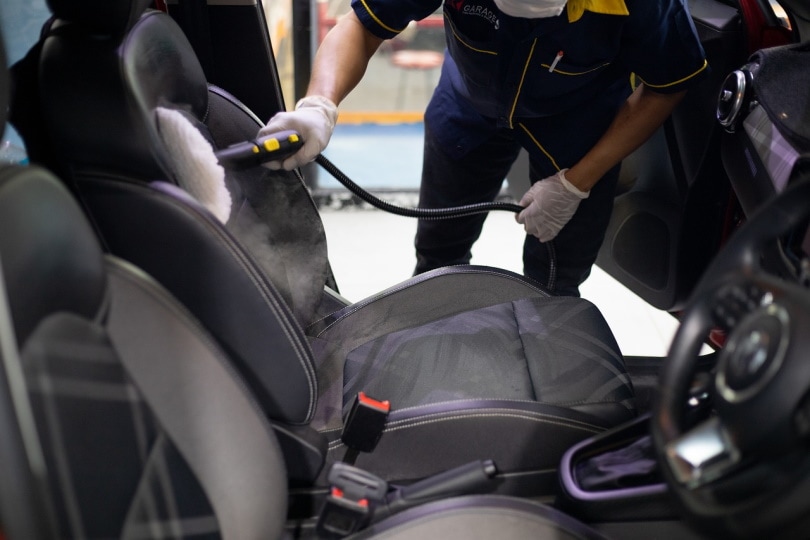 man cleaning car seat