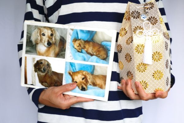 man holding photo of his deceased dog