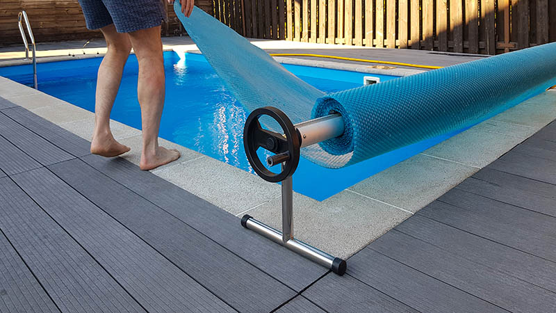 man putting pool cover