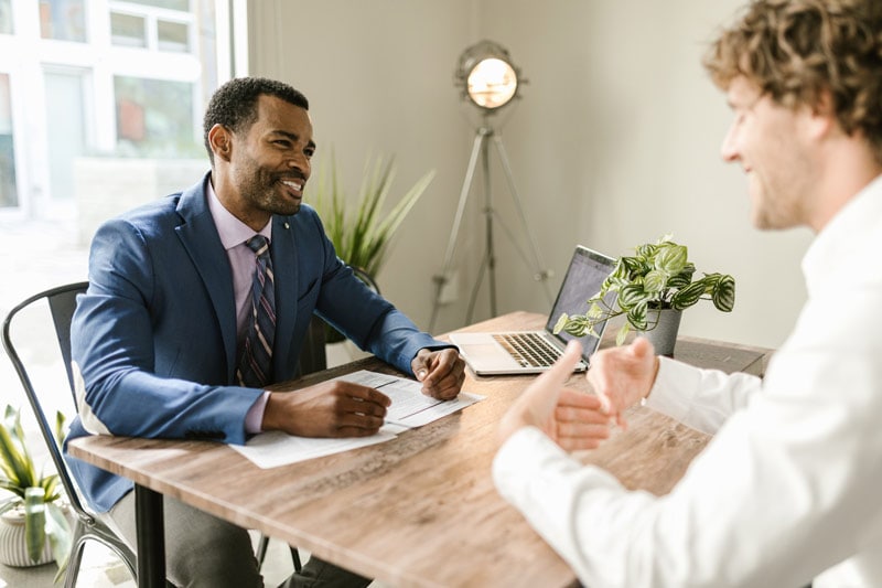 men sitting at the table discussing insurance