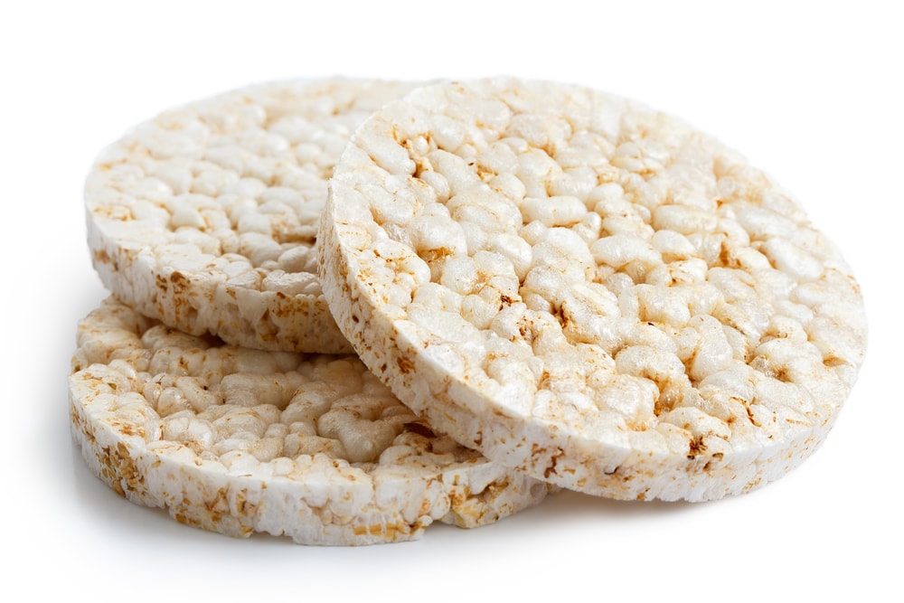 Pile of three puffed rice cakes isolated on white