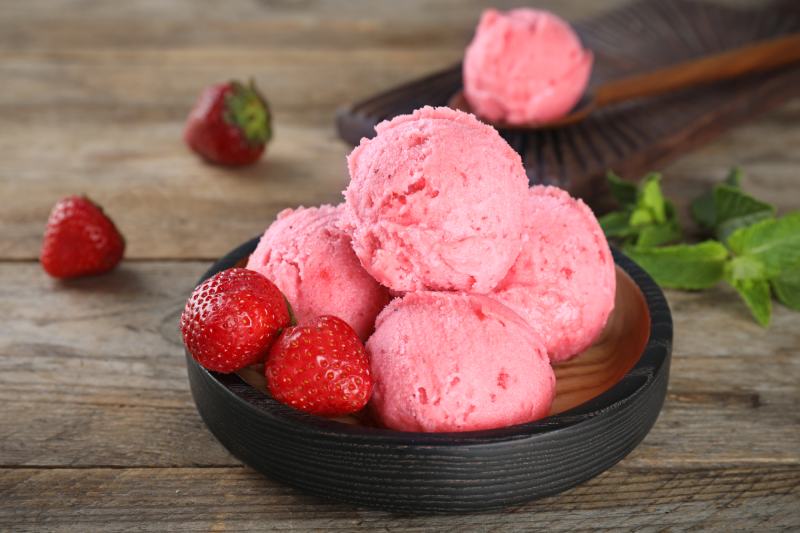 strawberry ice cream on wooden table