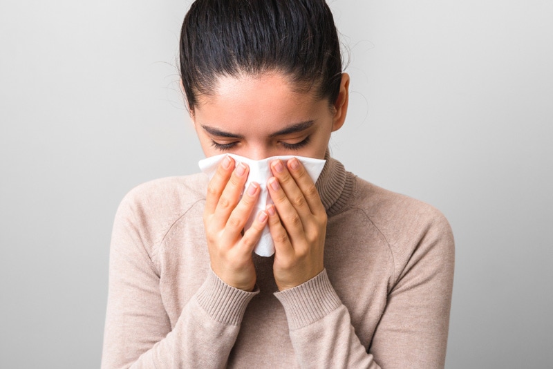 woman coughing or sneezing