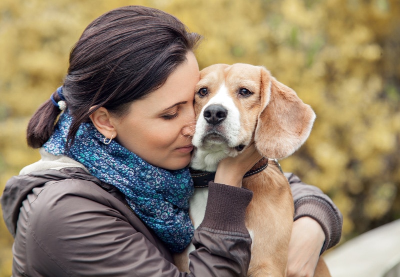 woman hugging her dog outdoor