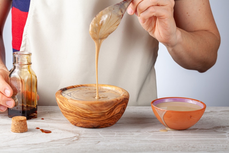 woman mixing tahini