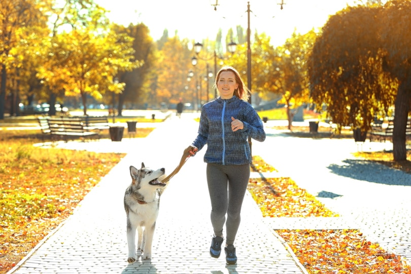 woman running with her dog