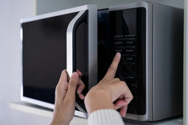 woman using microwave