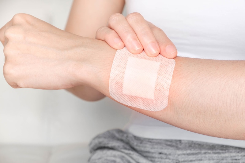 woman with bandage on arm