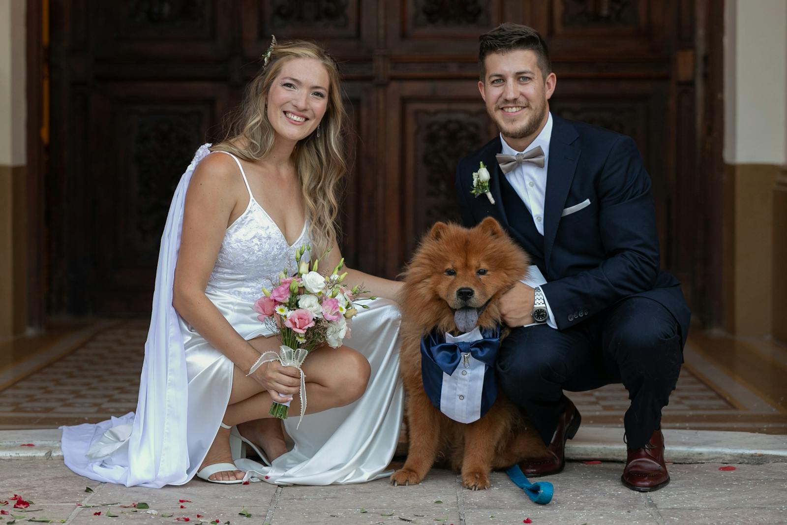Couple with a dog on their wedding