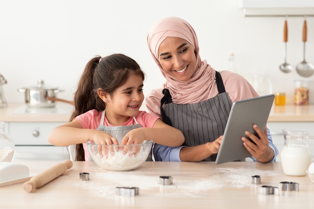 Mother Baking With Little Daughter At Home