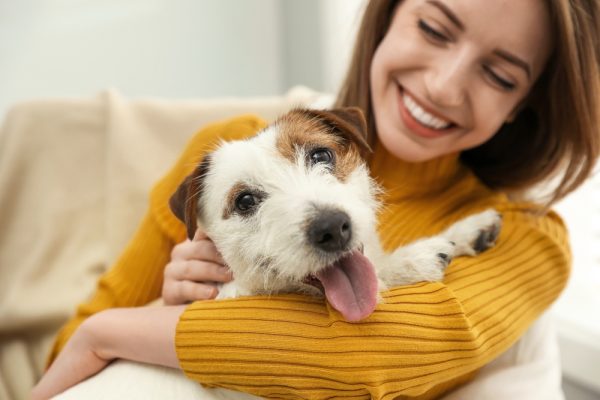a happy woman with her jack russell terrier dog