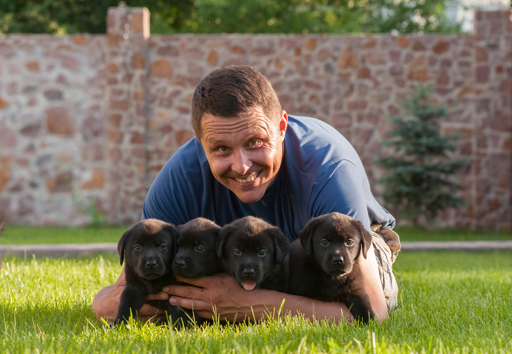 dog breeder with puppies outside