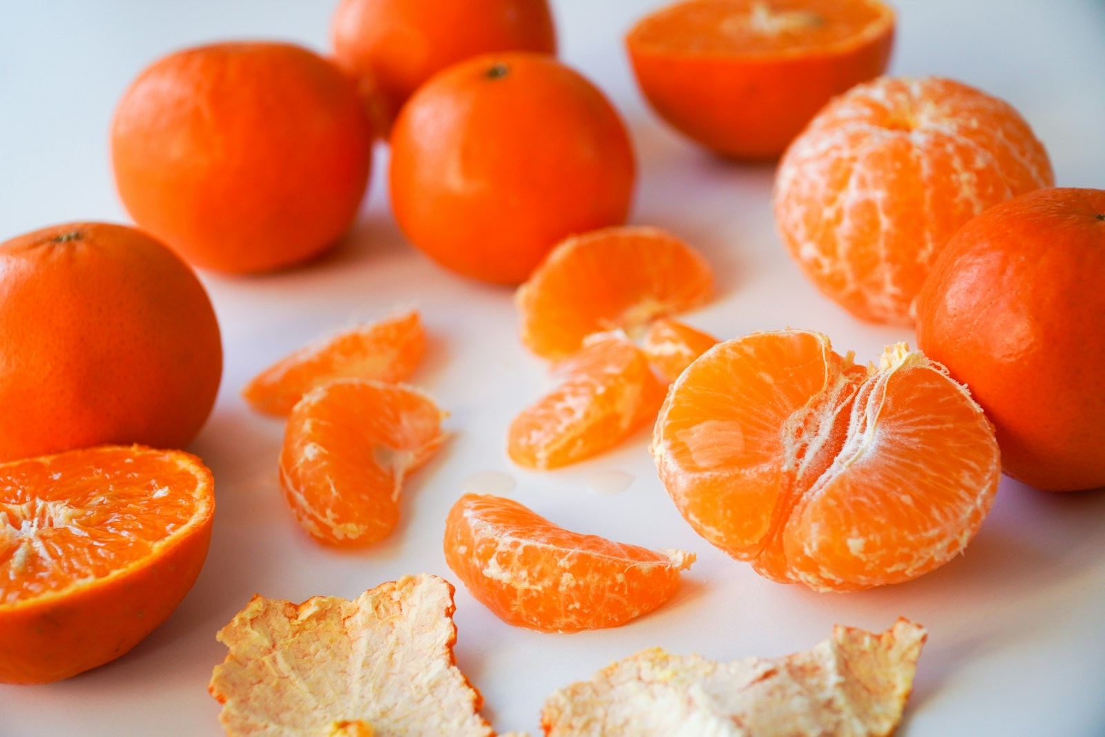 sliced tangerines on white ceramic plate