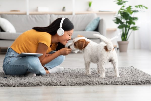 woman listening to music with her dog