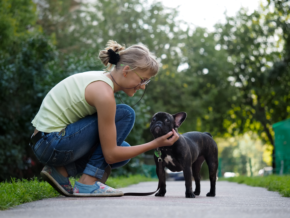 woman with her french bulldog outdoors