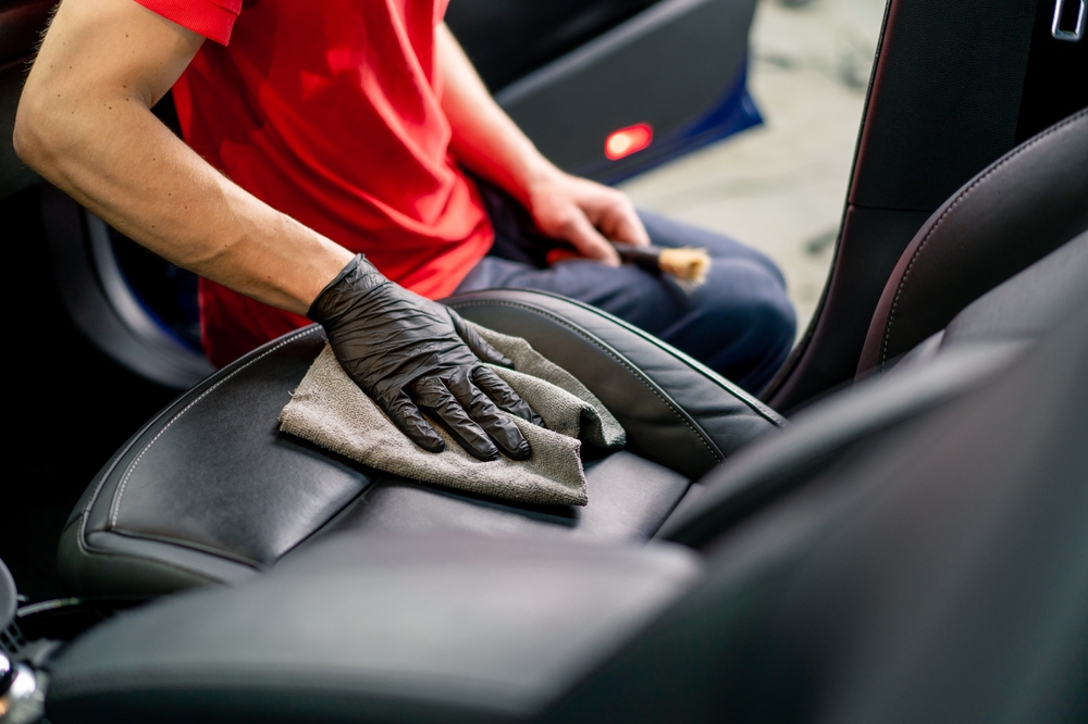Person cleaning car seat