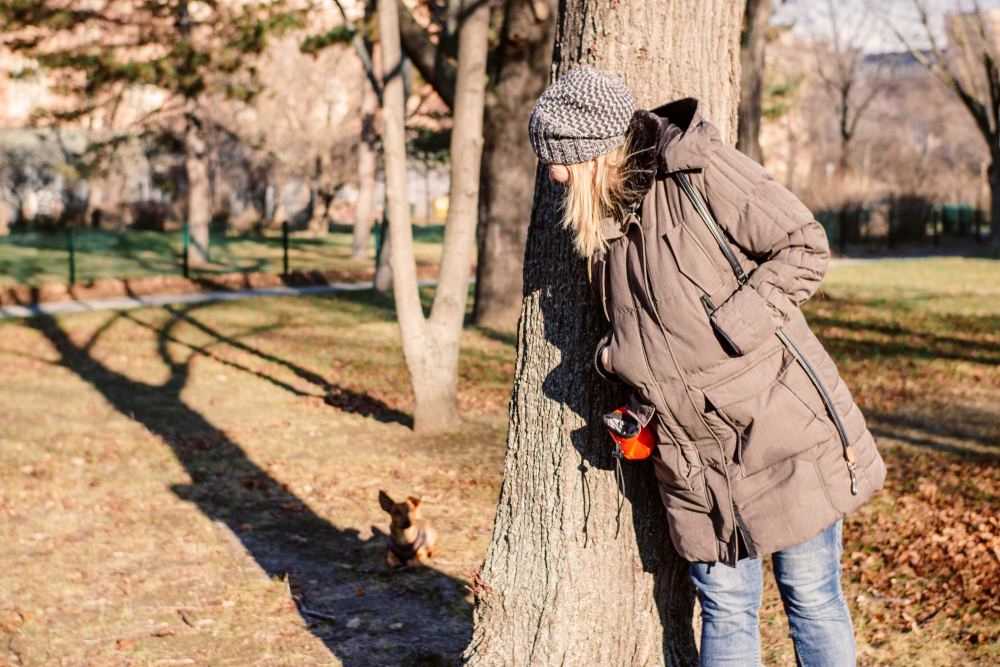 Woman-and-her-little-dog-playing-hide-and-seek
