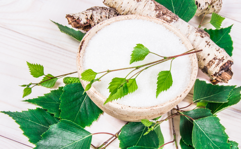 Xylitol - sugar substitute for diabetics or Birch sugar on white wooden background