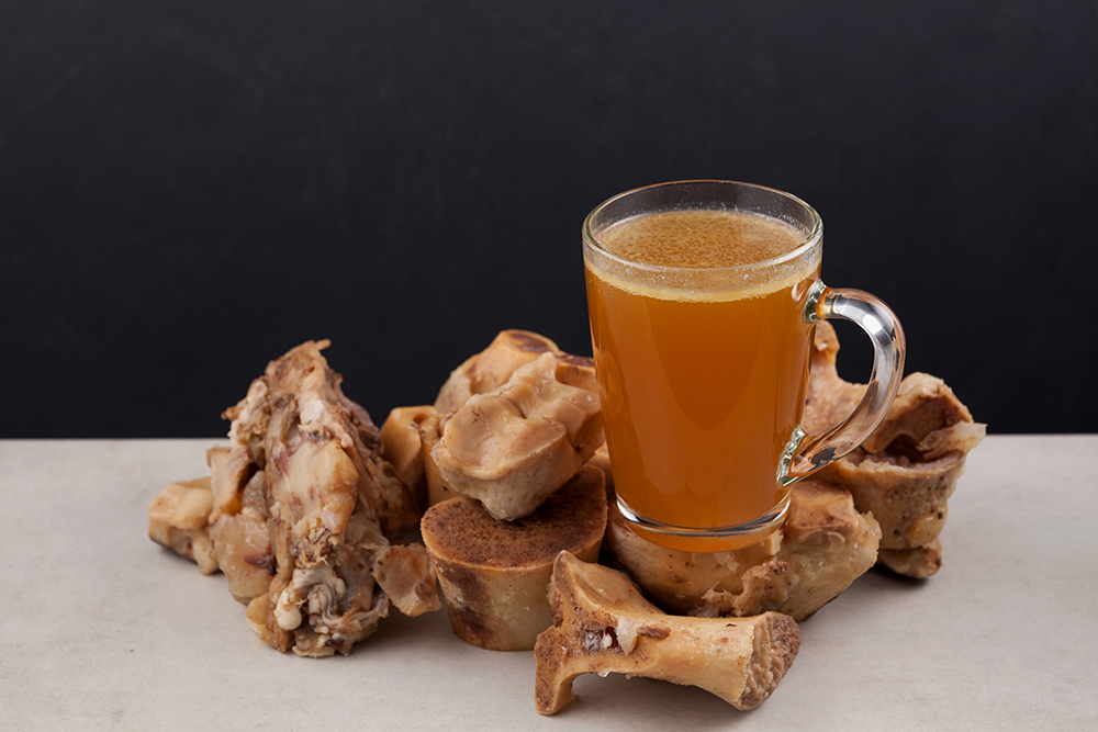 beef bones and a glass of bone broth