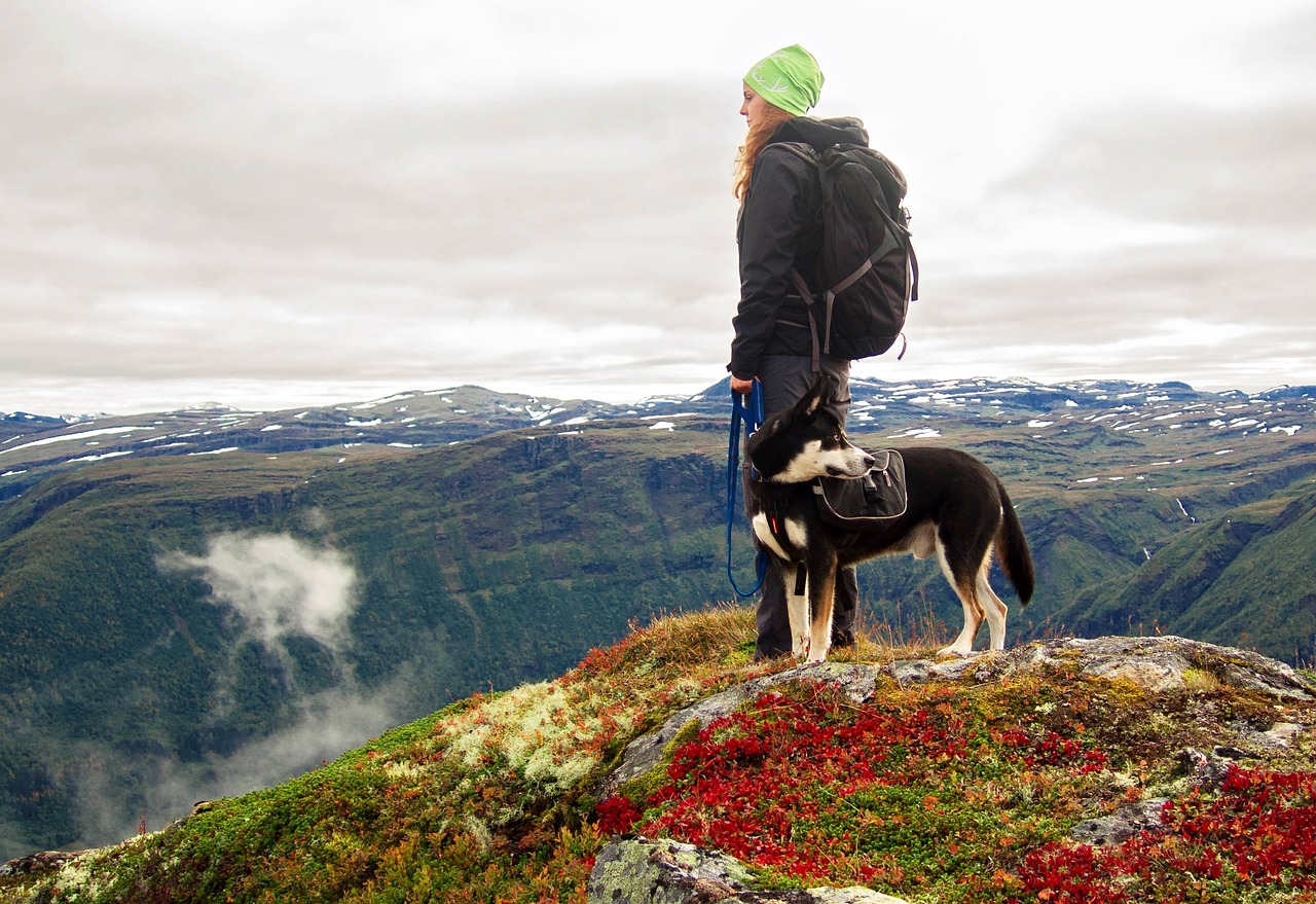 girl hiking with her pet husky