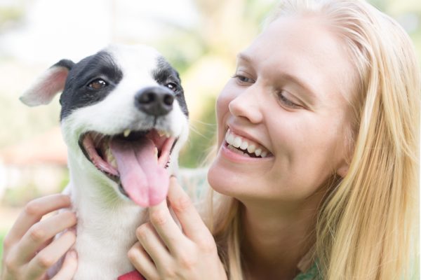 happy dog owner and pet outdoors