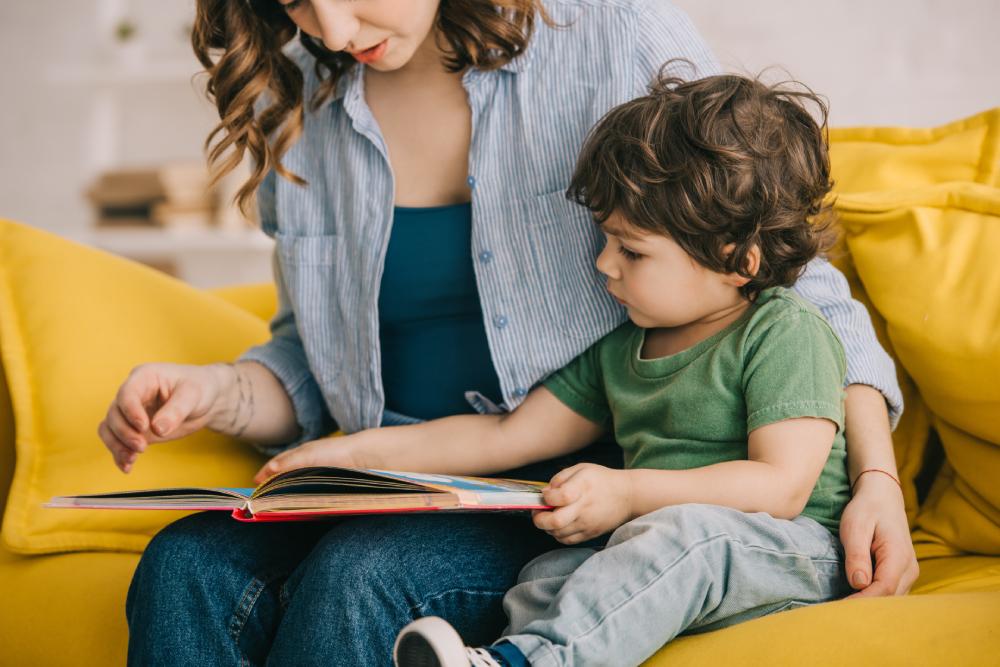 mother and son reading book together