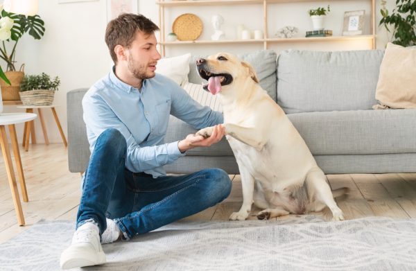 man-with-his-dog-sitting-on-the-floor