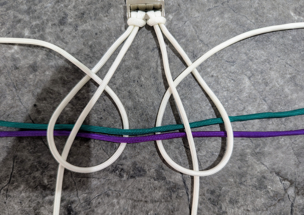 14. Take the end of color 1 and loop it over and under the center strands and the other two colors