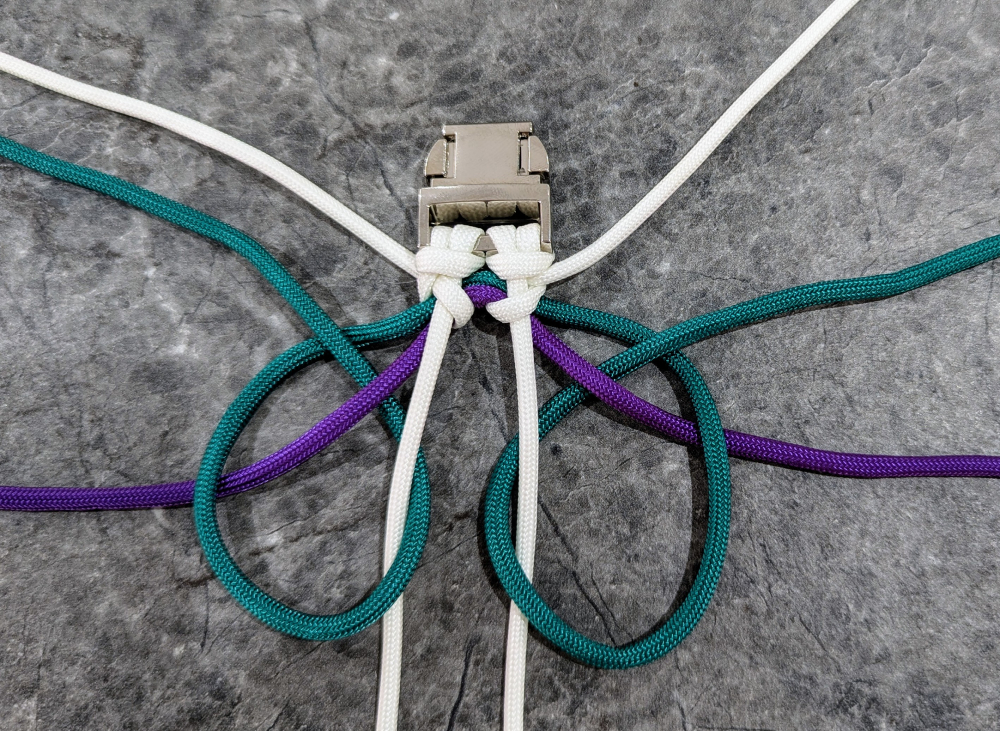 16. Take color 2 and loop it over and under color 3 and the central cord, but do not tighten it yet