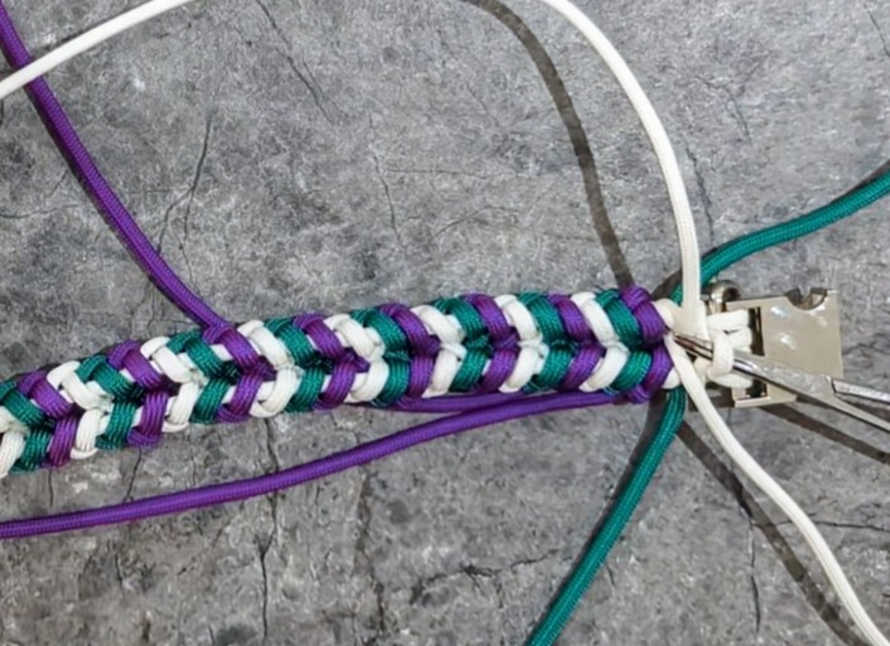 22. On the underside, pull the ends of color 1 and color 2 through the loop from the original tie